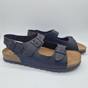 Sandalias Interbios de dos hebillas y trasera en color marrón, con diseño cómodo y elegante para mujer.